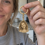 Custom Laser-Cut Portrait Keychain customer photo - woman holding gold portrait keychain up in a kitchen Anthology Jewelry