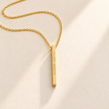 Custom medium column necklace in gold on pale cream