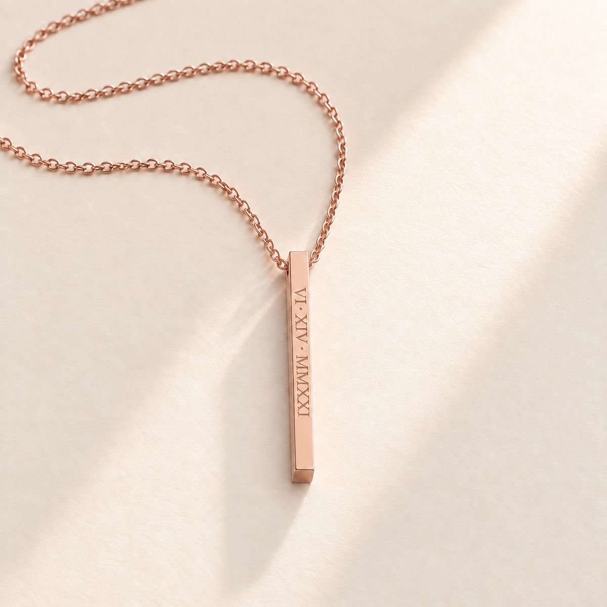 Custom medium column necklace in rose gold on pale cream