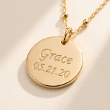 Custom Memorial Bracelet detail photo - close-up of engraved name and date on gold disc Anthology Jewelry