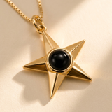 Custom Memorial Star Necklace detail photo - close-up of faceted gold star and black projection stone Anthology Jewelry
