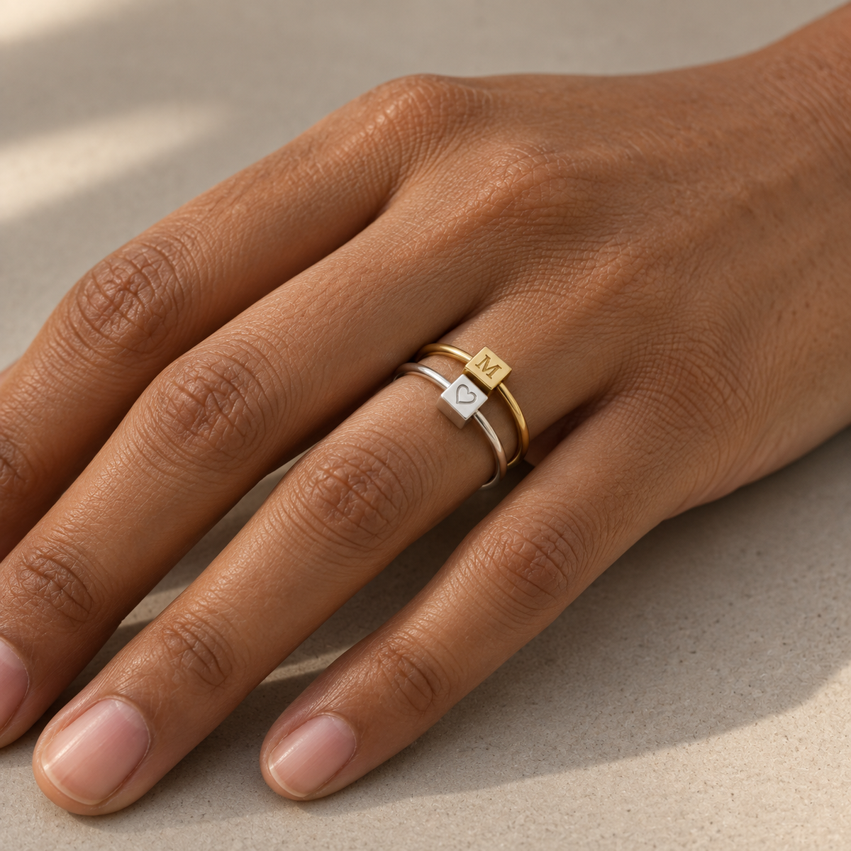 Gold and silver Mini Block Rings stacked on a hand