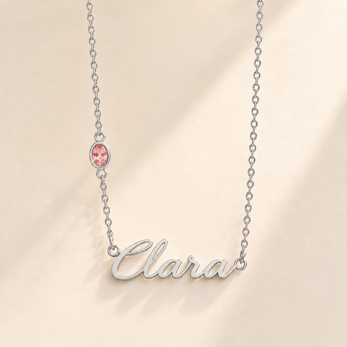 Silver script Clara necklace with pink stone on left chain