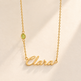 Gold script Clara necklace with august birthstone-color stone on left chain