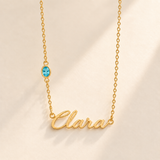 Gold script Clara necklace with december birthstone-color stone on left chain