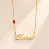 Gold script Clara necklace with july birthstone-color stone on left chain