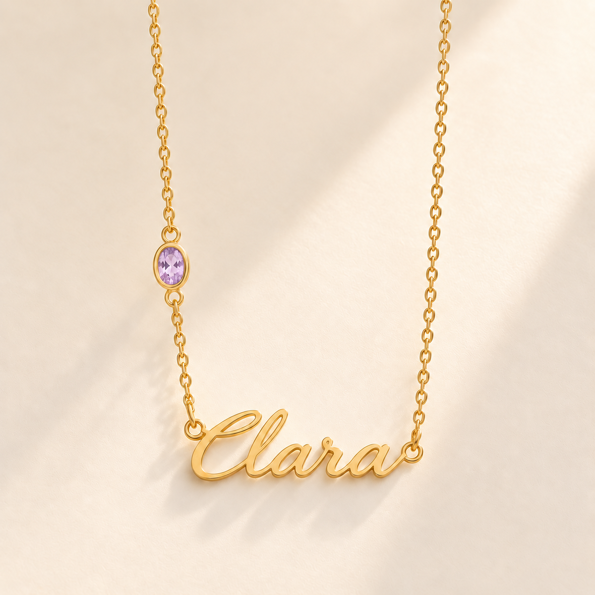 Gold script Clara necklace with june birthstone-color stone on left chain