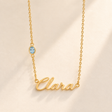 Gold script Clara necklace with march birthstone-color stone on left chain