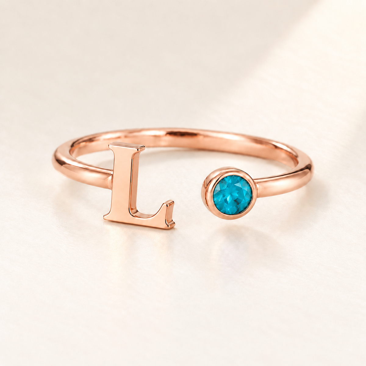 Custom Open Birthstone Initial Ring, rose gold december birthstone variant image; ivory background