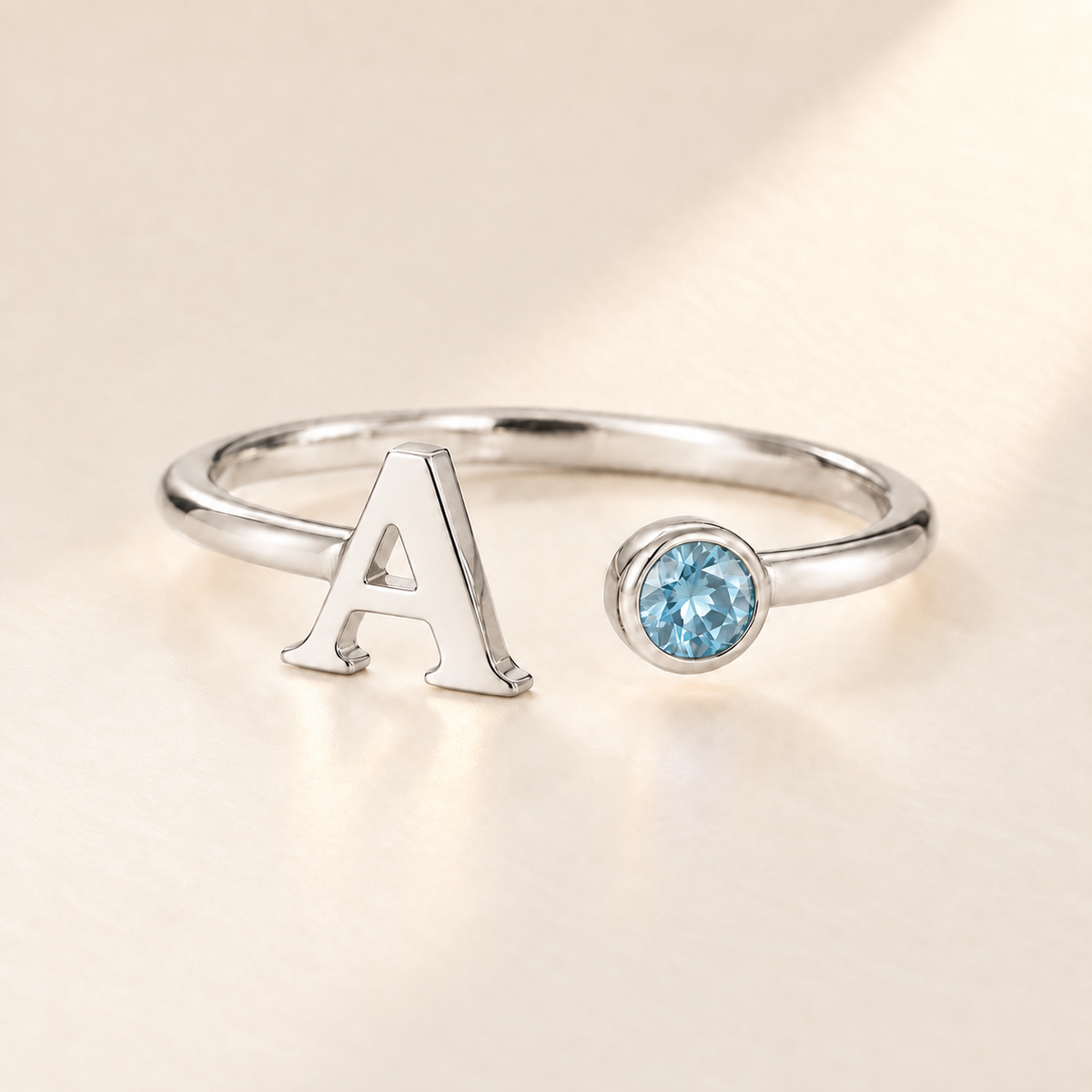 Custom Open Birthstone Initial Ring, silver march birthstone variant image; ivory background