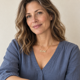 Woman wearing a gold ELISE pavé name necklace in a natural portrait