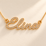 Close view of tiny clear stones in Elina script nameplate and two chain attachments