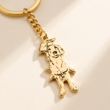 Custom Pet Keychain detail photo - close-up of engraved gold pet silhouette charm Anthology Jewelry