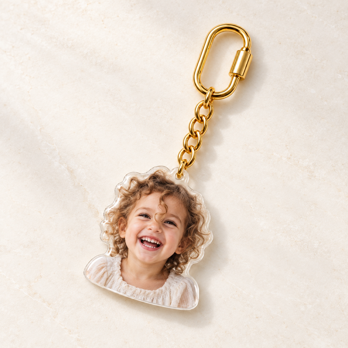 Gold custom photo bag charm with a laughing child portrait