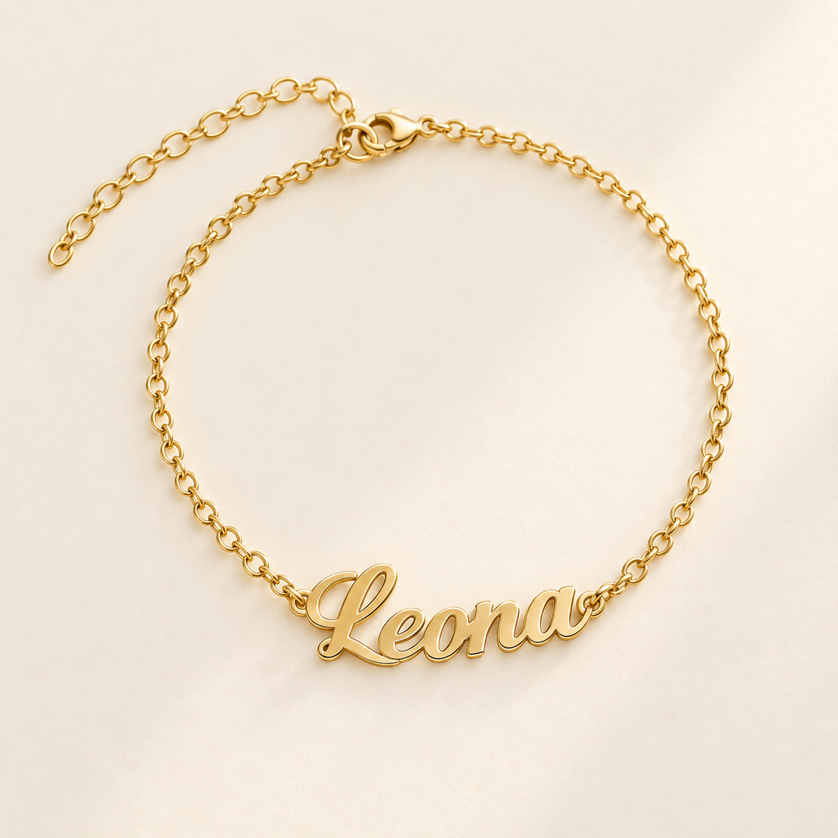 Custom Script Name Bracelet hero photo - gold Leona cutout script name bracelet on cream Anthology Jewelry