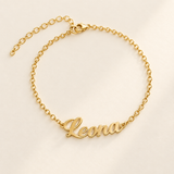 Custom Script Name Bracelet hero photo - gold Leona cutout script name bracelet on cream Anthology Jewelry