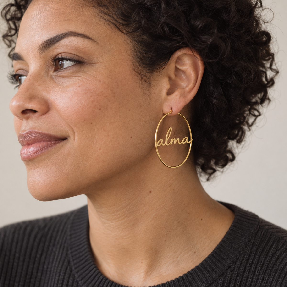 Custom Script Name Hoop Earrings close worn photo - gold script name hoop on the ear Anthology Jewelry