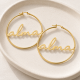 Custom Script Name Hoop Earrings glamour photo - gold script name hoops worn as a pair Anthology Jewelry