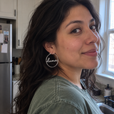 Custom Script Name Hoop Earrings in Silver, candid phone-style marketing image with luna lowercase cutout name - Anthology Jewelry
