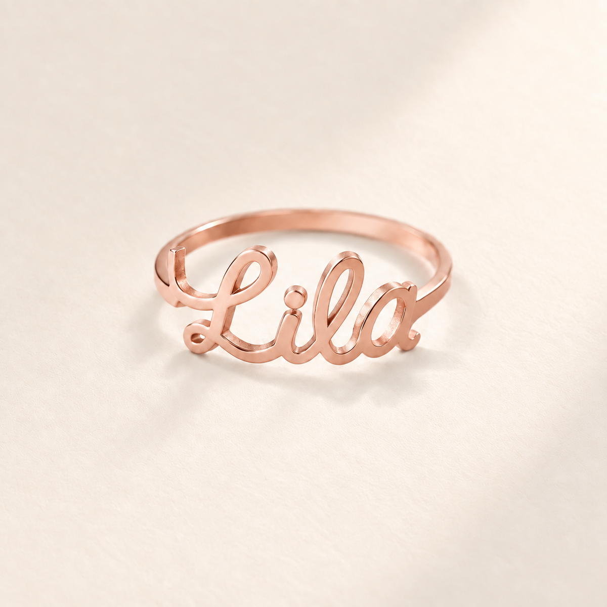 Custom Script Name Ring hero photo - rose gold ring with a cutout cursive name across the front Anthology Jewelry