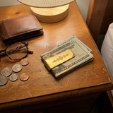 Custom Soundwave Money Clip UGC photo - gold money clip holding folded cash on nightstand Anthology Jewelry