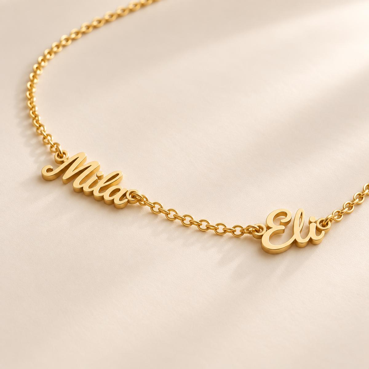 Custom Spaced Names Necklace glamour photo - two script names spaced along a gold rolo chain Anthology Jewelry