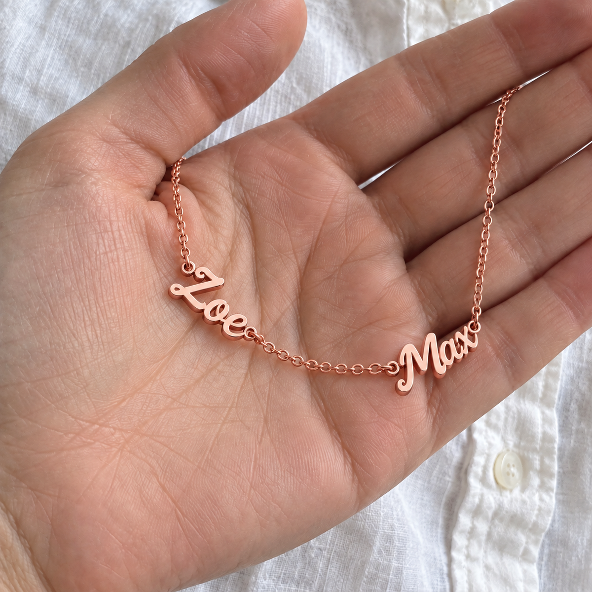 Custom Spaced Names Necklace UGC-style photo - rose gold finish with Zoe / Max personalization Anthology Jewelry