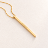 Custom Thin Column Necklace glamour photo - gold column pendant lying on cream surface Anthology Jewelry