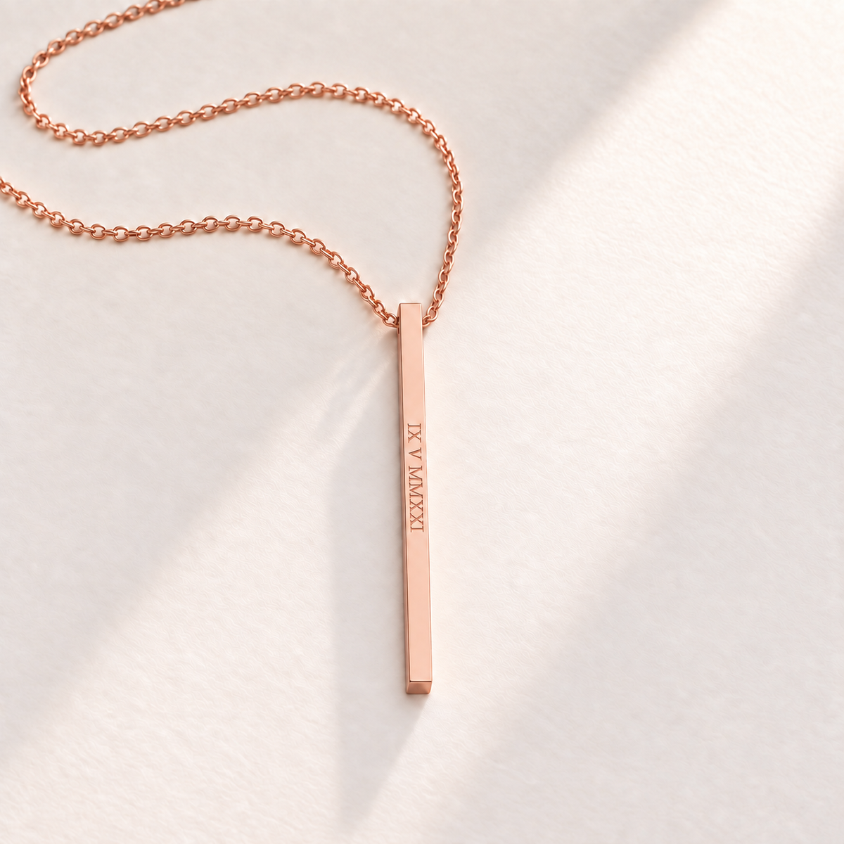 Custom Thin Column Necklace rose gold hero photo - column pendant engraved with a Roman numeral date Anthology Jewelry