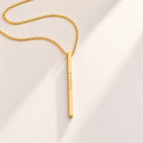 Custom Thin Column Necklace hero photo - gold column pendant engraved with a Roman numeral date Anthology Jewelry