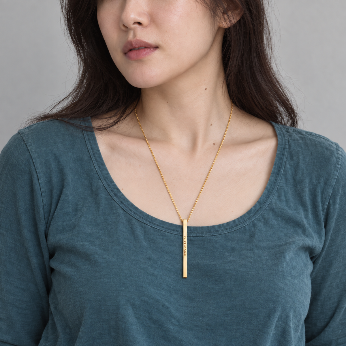 Custom Thin Column Necklace lifestyle photo - woman in teal top wearing gold column necklace Anthology Jewelry