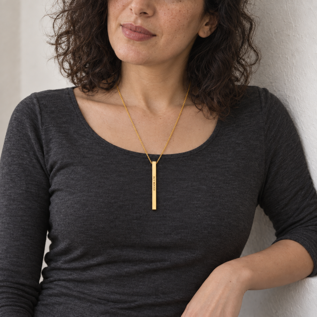 Custom Thin Column Necklace lifestyle photo - woman in charcoal top wearing gold column necklace Anthology Jewelry