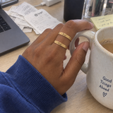 Custom Thin Double Ring customer photo - hand holding a mug at a desk wearing gold double band ring Anthology Jewelry