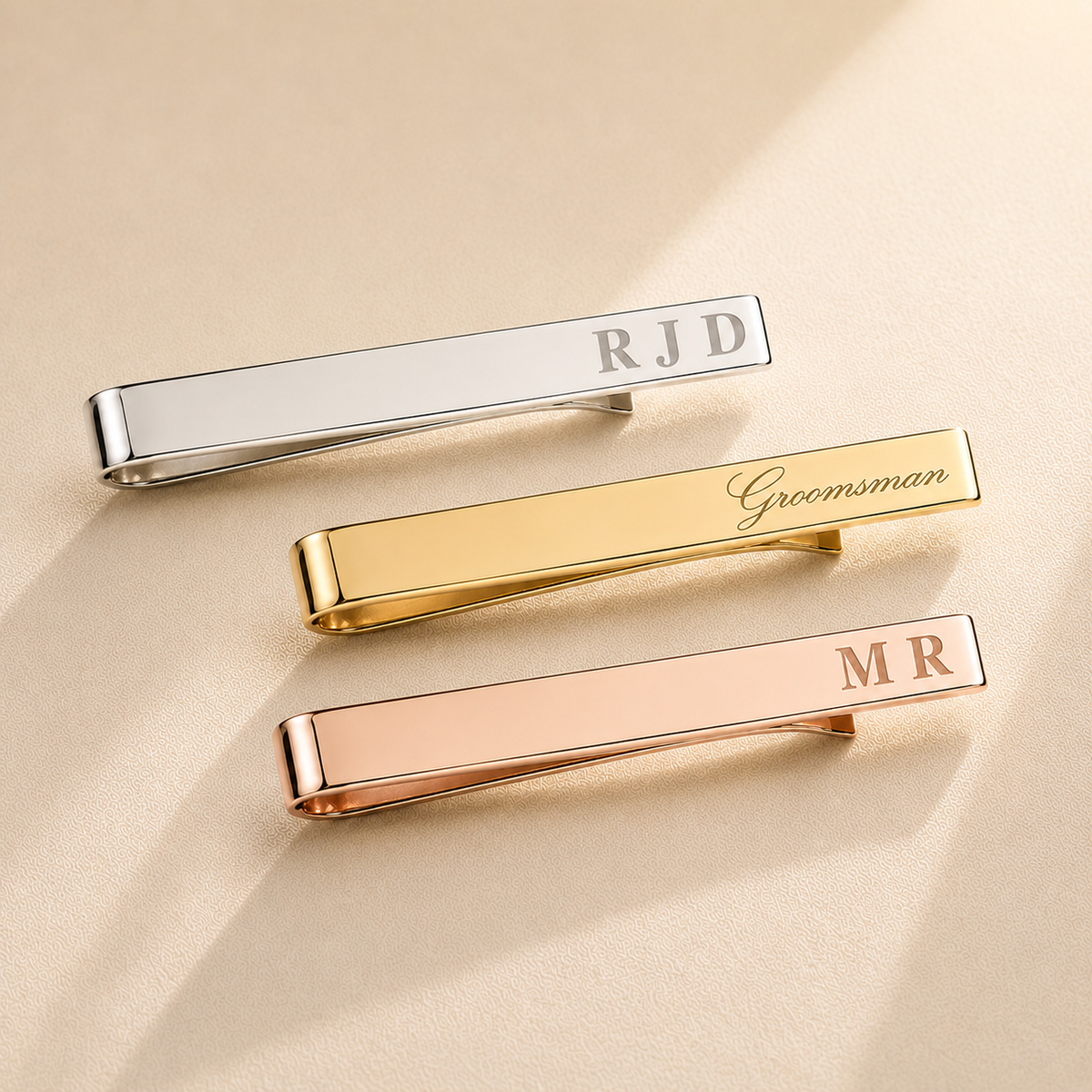 Custom engraved tie clip in rose gold finish, close-up detail