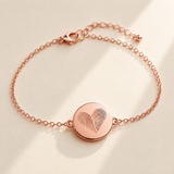 Custom Two Fingerprint Heart Bracelet hero photo - rose gold engraved disc bracelet on cream background Anthology Jewelry