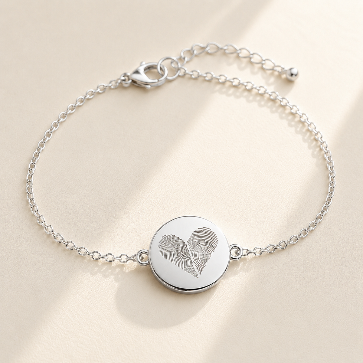 Custom Two Fingerprint Heart Bracelet hero photo - silver engraved disc bracelet on cream background Anthology Jewelry