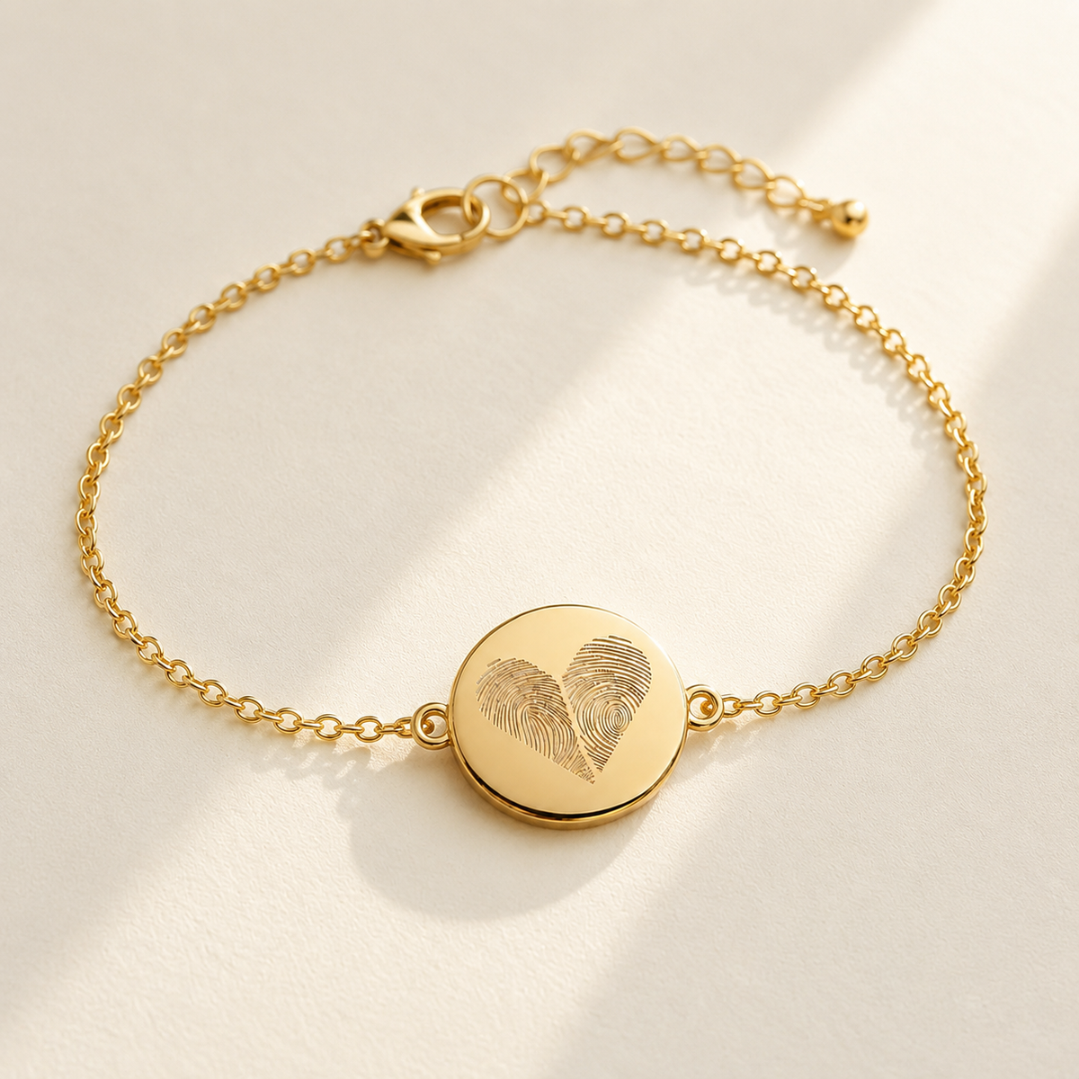 Custom Two Fingerprint Heart Bracelet hero photo - gold engraved disc bracelet on cream background Anthology Jewelry