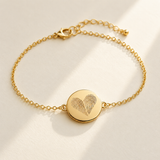 Custom Two Fingerprint Heart Bracelet hero photo - gold engraved disc bracelet on cream background Anthology Jewelry