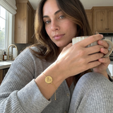 Custom Two Fingerprint Heart Bracelet UGC photo - gold bracelet worn at home with coffee Anthology Jewelry