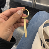 Casual transit phone photo of a custom vertical bar keychain