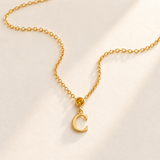 Gold vertical initial necklace with november birthstone-color center stone