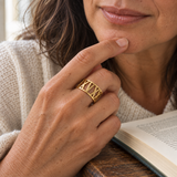 Custom Wide Cut Out Ring professional close photo - gold openwork band worn by woman reading Anthology Jewelry