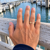 Custom Date & Name Birthstone Stacking Ring casual modeled photo - gold ring with NORA and 10.22 beside a pink tourmaline Anthology Jewelry