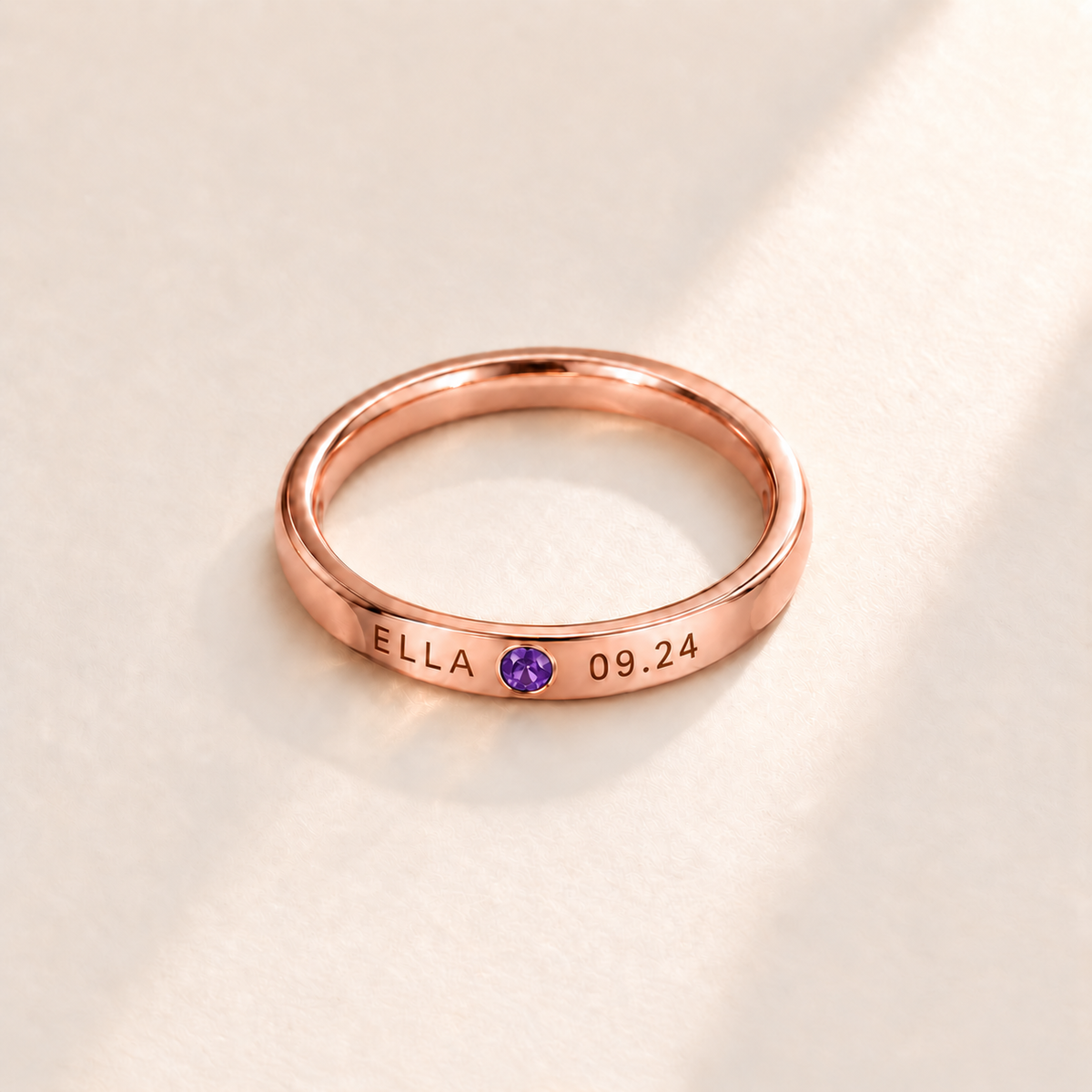 Custom Date & Name Birthstone Stacking Ring, February Amethyst, Rose Gold finish. Illustrative product rendering; natural gemstone colors may vary.