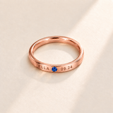 Custom Date & Name Birthstone Stacking Ring Rose Gold hero photo - ELLA and 09.24 engraving beside a blue birthstone Anthology Jewelry