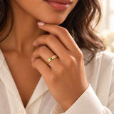 Custom Date & Name Birthstone Stacking Ring professional modeled photo - gold ring with MAYA and 05.18 beside a green emerald Anthology Jewelry