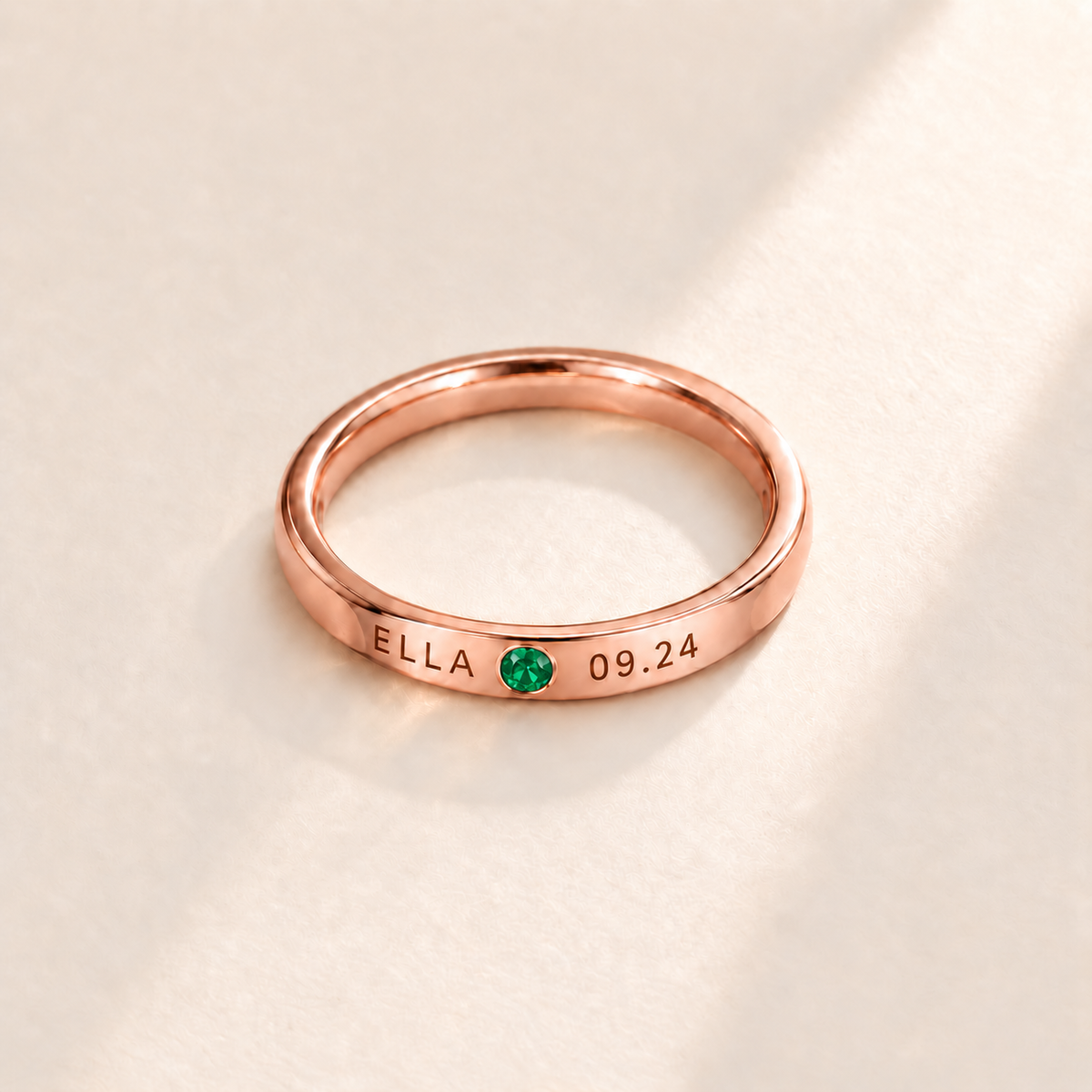 Custom Date & Name Birthstone Stacking Ring, May Emerald, Rose Gold finish. Illustrative product rendering; natural gemstone colors may vary.