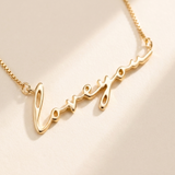 "Loveyou" Necklace detail photo - close-up of polished gold script lettering Anthology Jewelry